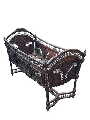 Lot 2256 - A 19th century carved oak cradle, with angel...