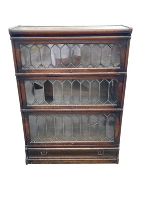 Lot 2148 - GLOBE-WERNICKE; a three tier bookcase with up...