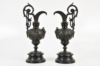 Lot 1399 - A pair of reproduction bronze ewers, with...