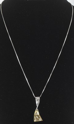 Lot 1215 - An 18ct white gold pendant, set with assorted...