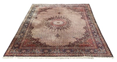 Lot 86 - A large modern Persian style red ground rug,...