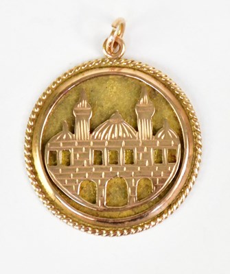 Lot 1070 - A 14ct yellow gold circular pendant depicting...