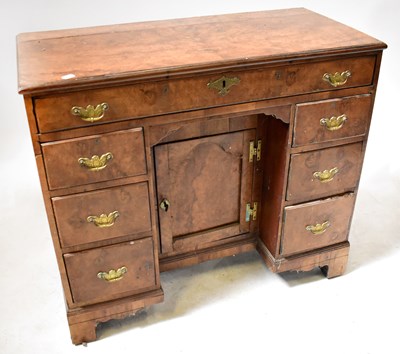 Lot 119 - A Georgian walnut kneehole desk, with an...