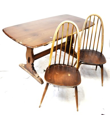 Lot 37 - ERCOL; a dark elm pine refectory kitchen table,...