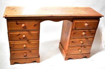 Lot 108 - A modern waxed pine kneehole desk with an...