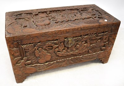 Lot 87 - A Chinese camphorwood chest, profusely carved...