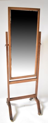Lot 135 - A vintage oak framed cheval mirror, raised on...