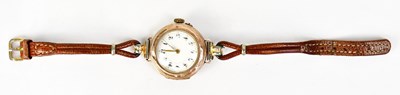 Lot 1177 - A yellow metal wristwatch, the dial set with...