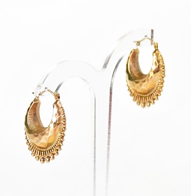 Lot 1100 - A pair of 9ct yellow gold crescent-shaped hoop...