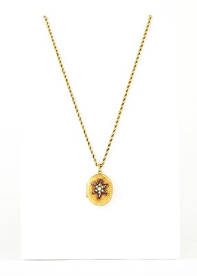Lot 1082 - A yellow metal oval locket pendant with relief...