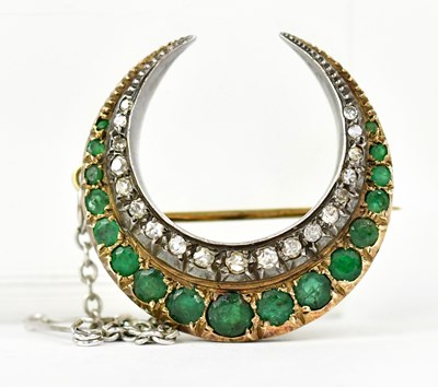 Lot 1064 - A yellow metal crescent brooch set with white...