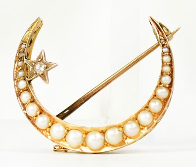 Lot 1063 - A yellow metal crescent-shaped brooch set with...