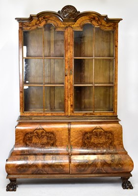 Lot 1558 - A reproduction figured walnut display cabinet in the Dutch style