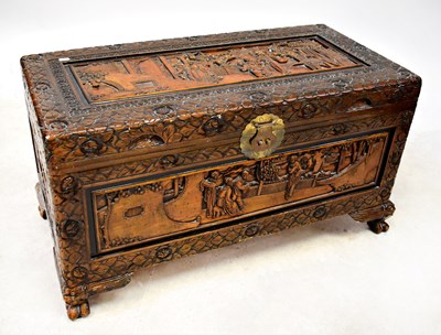 Lot 551 - A Chinese carved camphorwood chest, with...
