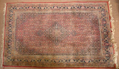 Lot 2669 - A red ground Herat Persian rug with central...