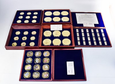 Lot 985 - Four case sets of gold-plated commemorative...