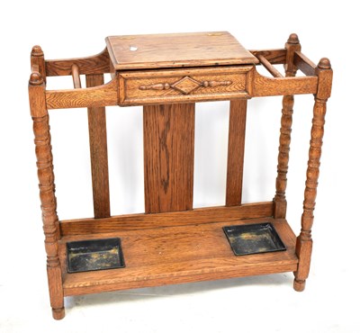 Lot 63 - An early 20th century oak umbrella/stick stand...