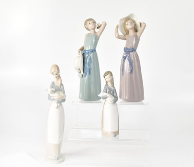Lot 167 - LLADRÓ; four Lladrό figures of girls, two with...