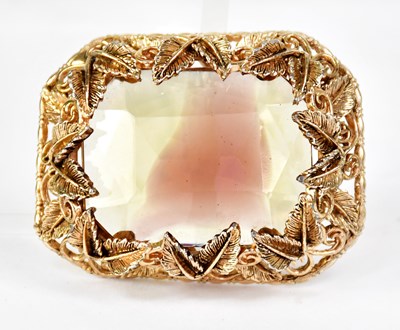 Lot 1066 - A gold-plated brooch decorated with scrolls...