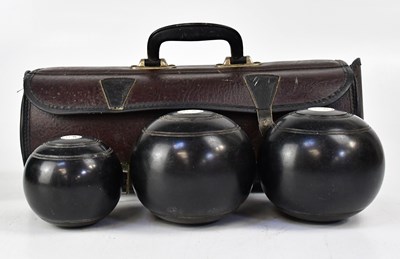 Lot 778 - A set of three lignum vitae bowls, in carrying...