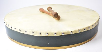 Lot 533 - A bodhrán drum with green and gold painted...
