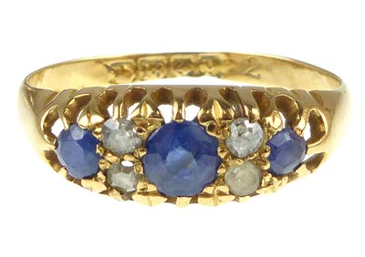 Lot 1024 - An 18ct gold diamond and sapphire ring, the...