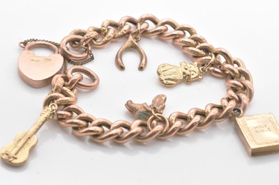 Lot 470 - A 9ct rose gold curb link bracelet set with...