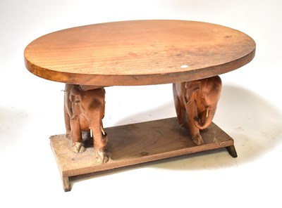 Lot 11 - A carved wooden oval top side table, the...