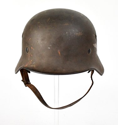 Lot 506 - A WWII German M42 steel helmet with folded lip,...