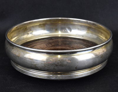 Lot 915 - An Elizabeth II hallmarked silver wine coaster...