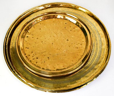 Lot 784 - Two large Eastern brass Benares table trays,...