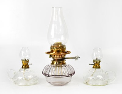 Lot 148 - A pair of pressed glass oil lamps with loop...