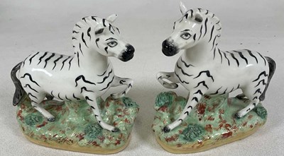 Lot 211 - A pair of Staffordshire zebras, 20 x 18cm.