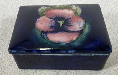 Lot 257 - MOORCROFT; a rectangular lidded trinket dish...