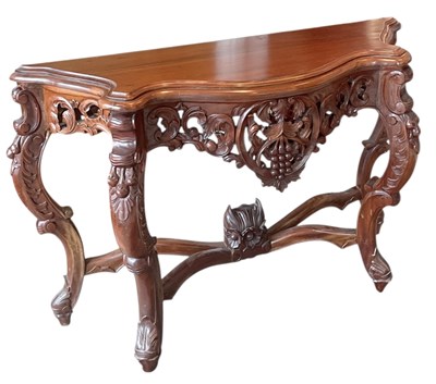 Lot 58 - A reproduction carved mahogany serpentine...