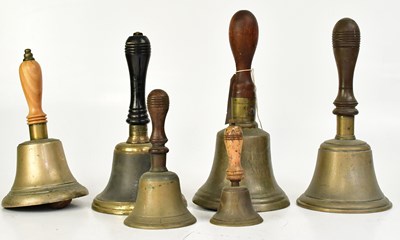 Lot 638 - Six vintage brass hand bells with turned...