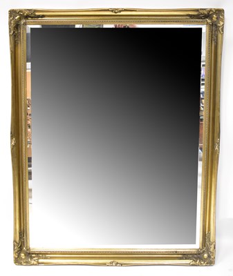 Lot 133 - A large gilt framed wall mirror with bevelled...