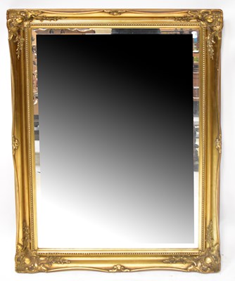 Lot 129 - A large gilt framed wall mirror with bevelled...