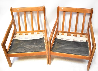 Lot 24 - A pair of mid-20th century teak open elbow...