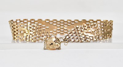 Lot 1051 - A yellow metal flat chain link bracelet with...