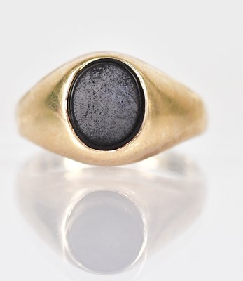 Lot 1038 - A gold ring set with oval onyx, marks rubbed,...