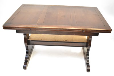 Lot 1 - ERCOL; a dark elm draw-leaf table, raised on...
