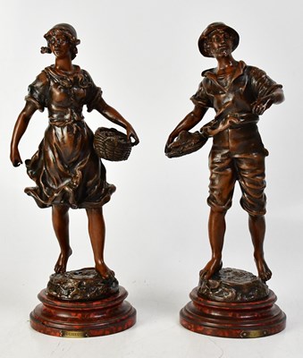 Lot 557 - A pair of spelter figures of a man holding a...