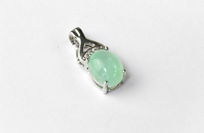 Lot 1182 - A silver pendant set with green opal and white...