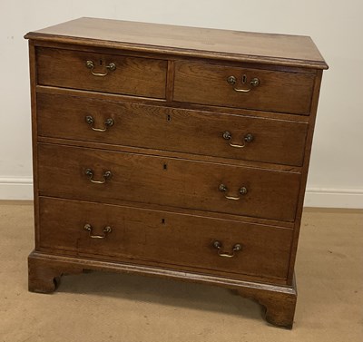 Lot 711 - A Georgian oak chest of two short over three...