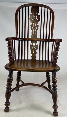 Lot 703 - An early 19th century yew Windsor high back...