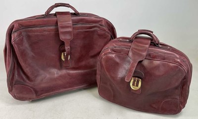 Lot 92 - Two vintage burgundy leather suitcases, both...