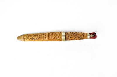 Lot 568 - A Scandinavian puukko knife with carved wooden...