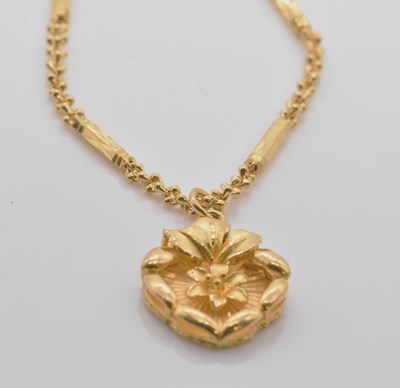 Lot 468 - A yellow metal floral pendant, suspended on a...