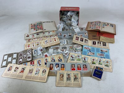 Lot 299 - A quantity of cigarette cards and stamps in...